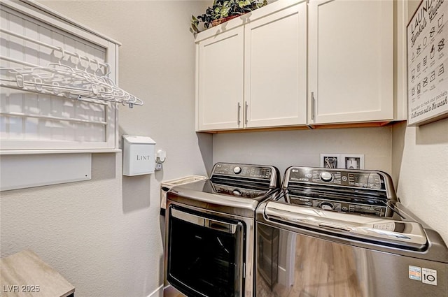 laundry room with cabinets and washer and dryer