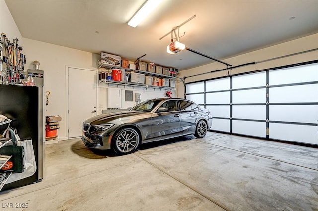 garage with a garage door opener and electric panel