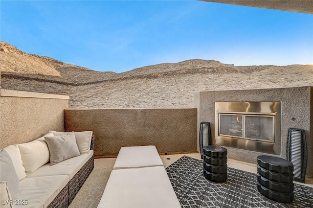 view of patio / terrace featuring a mountain view and an outdoor hangout area