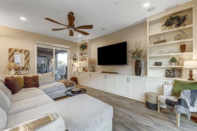 living room with ceiling fan, hardwood / wood-style floors, and built in features