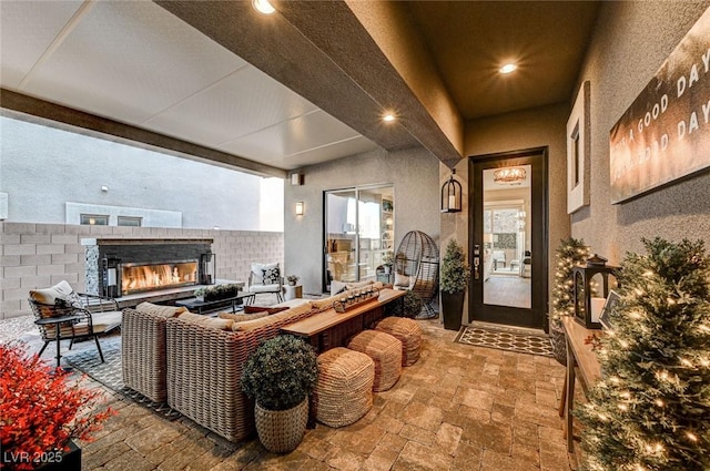 view of patio / terrace with an outdoor living space with a fireplace