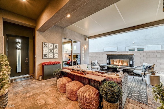 view of patio / terrace with an outdoor living space with a fireplace