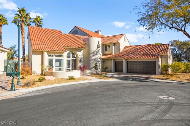 mediterranean / spanish-style house with a garage