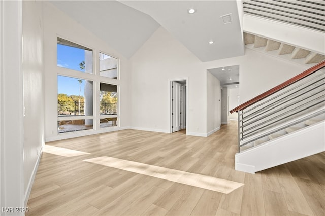 interior space featuring high vaulted ceiling and light hardwood / wood-style floors