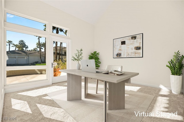 office space with high vaulted ceiling and light carpet