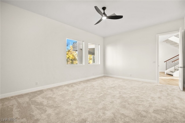 unfurnished room featuring light colored carpet and ceiling fan