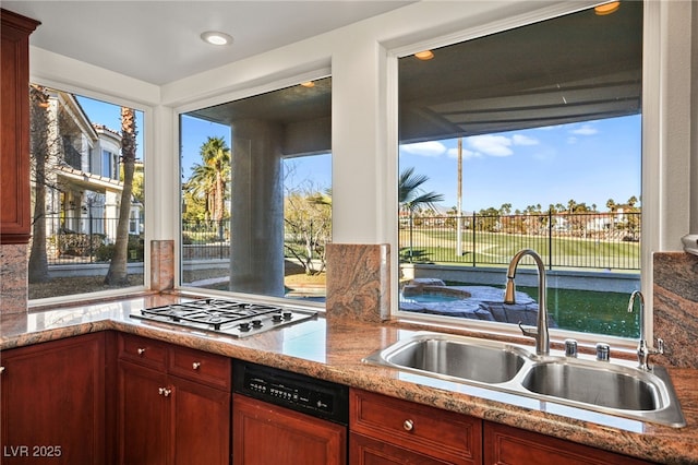 kitchen featuring sink, stainless steel gas stovetop, and dishwasher