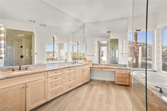 bathroom with vanity, hardwood / wood-style flooring, vaulted ceiling, and plus walk in shower