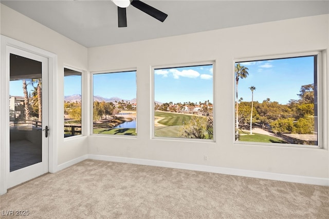 unfurnished sunroom with ceiling fan