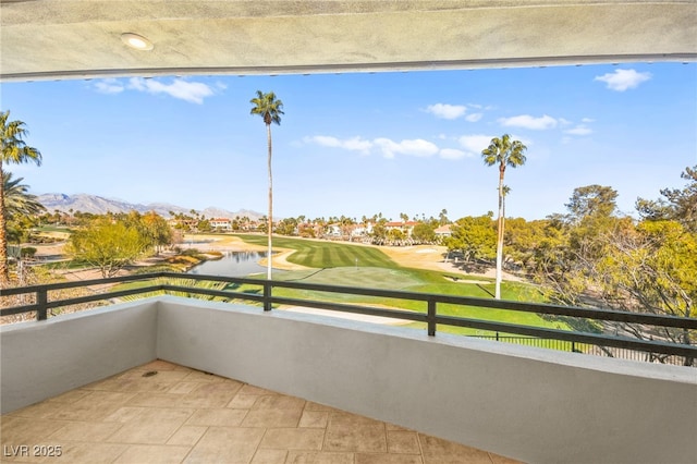 balcony featuring a water and mountain view