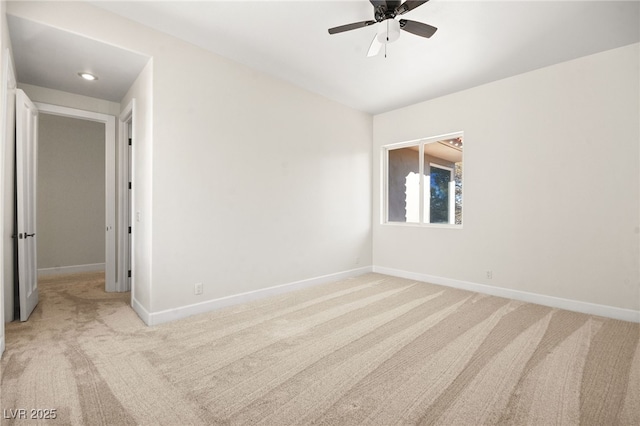 carpeted empty room featuring ceiling fan