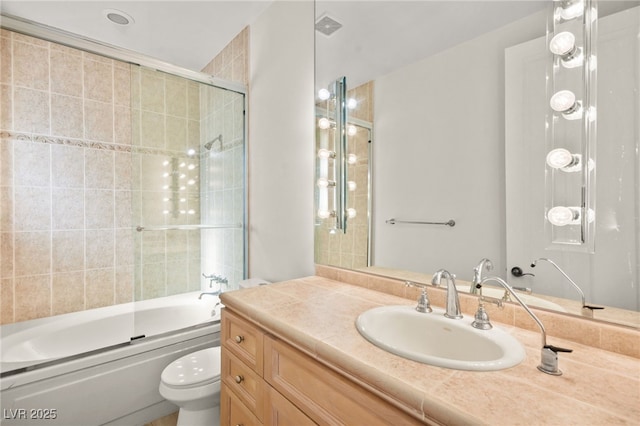 full bathroom with vanity, toilet, and combined bath / shower with glass door