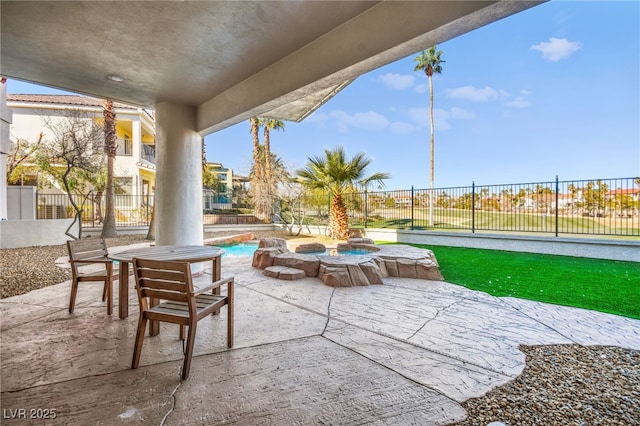 view of patio featuring a swimming pool with hot tub