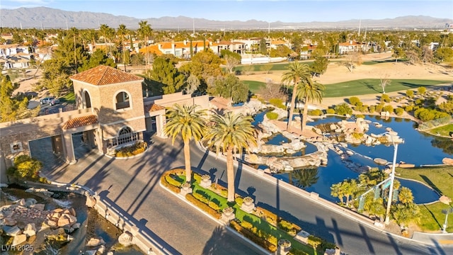 birds eye view of property with a water and mountain view