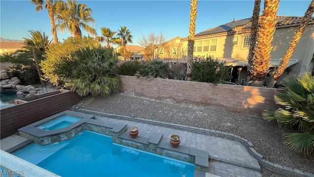 view of swimming pool featuring an in ground hot tub