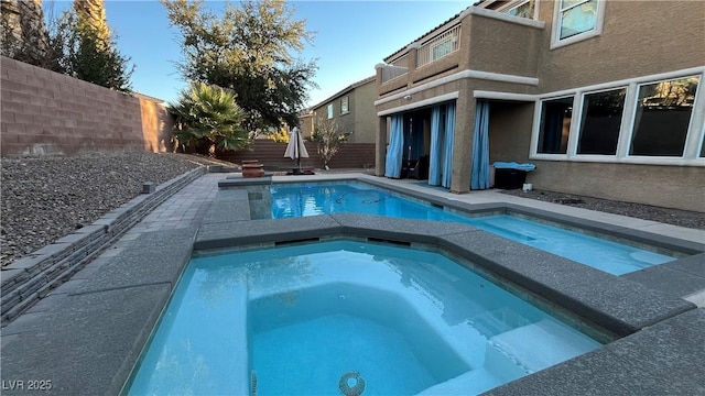 view of swimming pool featuring an in ground hot tub