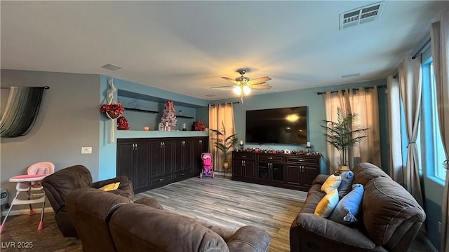 living room featuring ceiling fan and light wood-type flooring