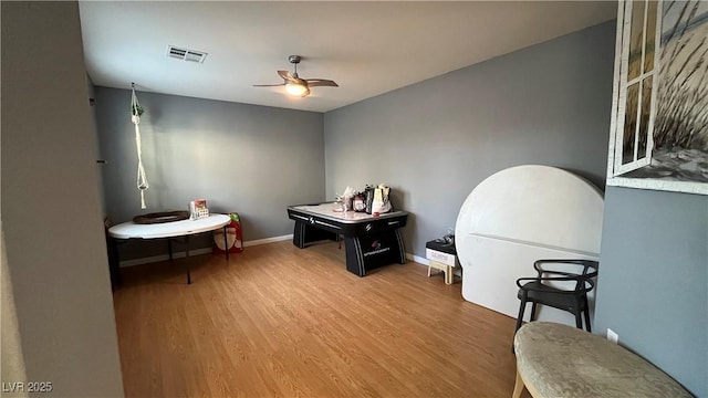 interior space with wood-type flooring and ceiling fan