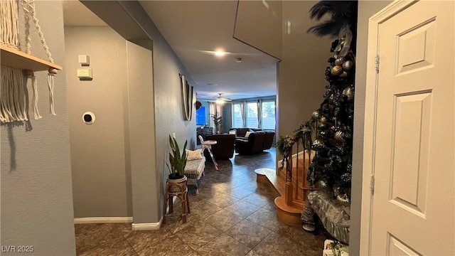 corridor featuring dark tile patterned flooring