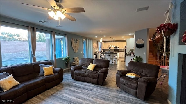 living room with hardwood / wood-style flooring and ceiling fan