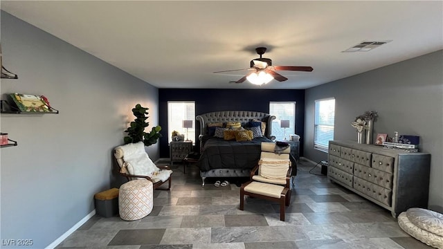 bedroom featuring multiple windows and ceiling fan