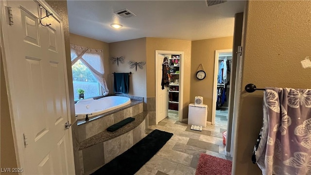 bathroom with tiled tub