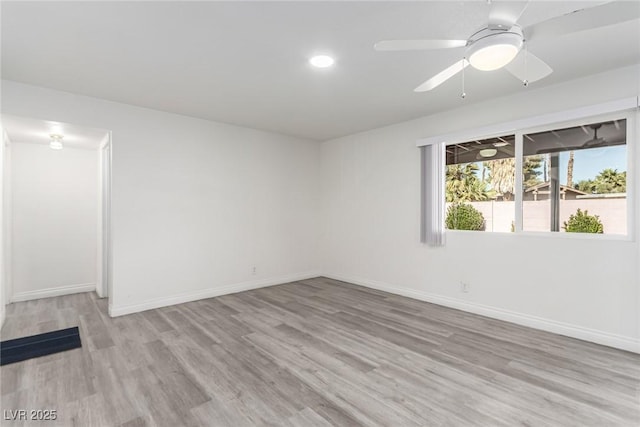 unfurnished room featuring ceiling fan and light wood-type flooring