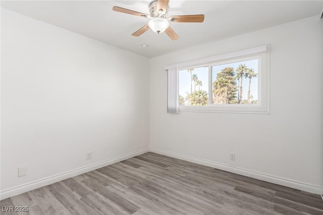 spare room with hardwood / wood-style flooring and ceiling fan