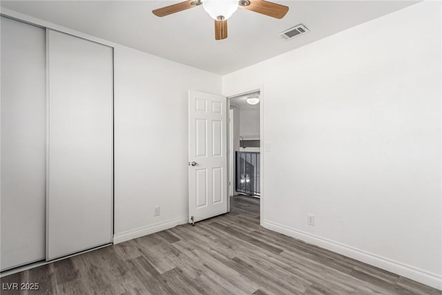 unfurnished bedroom with ceiling fan, light hardwood / wood-style floors, and a closet