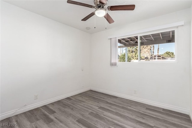 spare room featuring wood-type flooring and ceiling fan