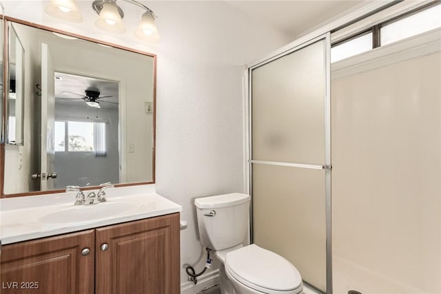 bathroom with vanity, a shower with shower door, and toilet