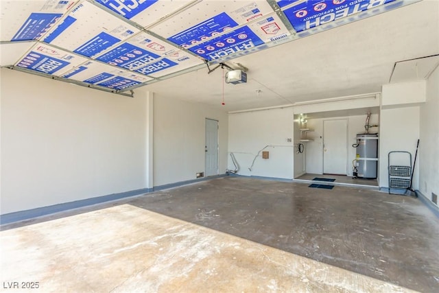 garage with a garage door opener and strapped water heater