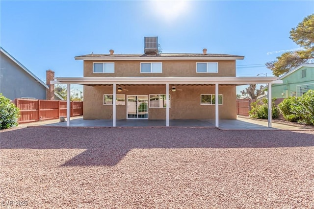 rear view of property featuring central AC unit, a patio, and ceiling fan