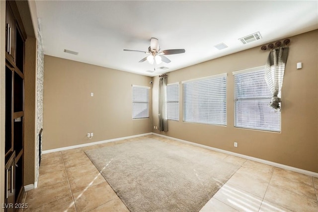 spare room with light tile patterned floors and ceiling fan