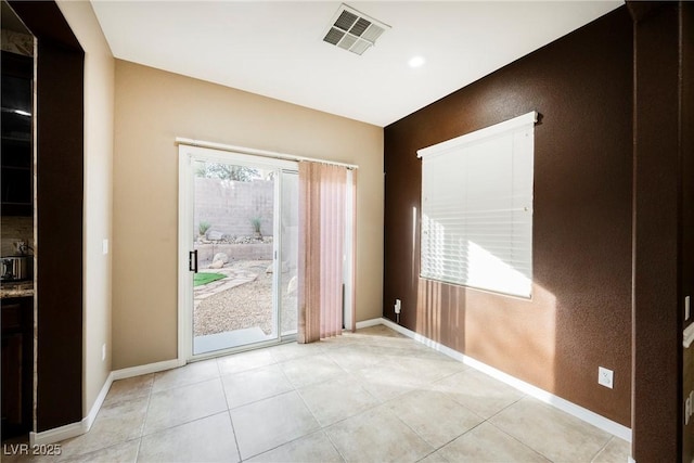 doorway with light tile patterned flooring