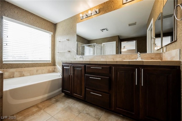 bathroom featuring vanity, tile patterned floors, and shower with separate bathtub