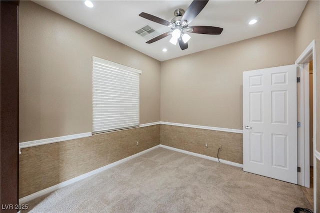 spare room with light carpet and ceiling fan