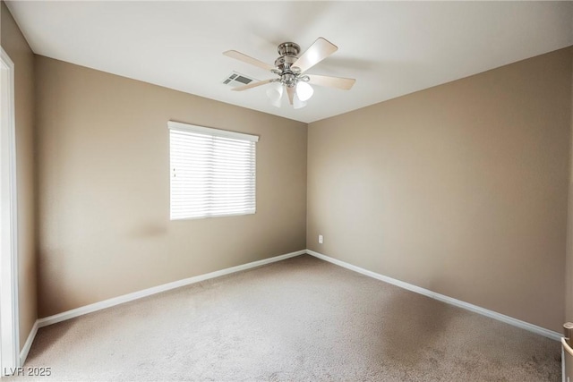 unfurnished room featuring ceiling fan and carpet