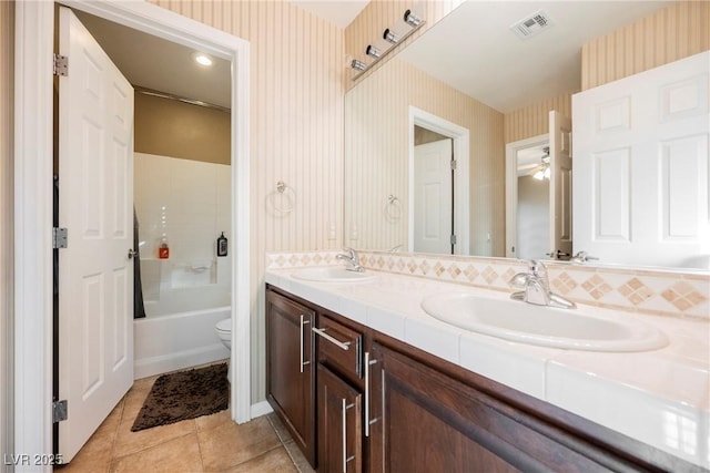 full bathroom with shower / washtub combination, toilet, tile patterned flooring, and vanity