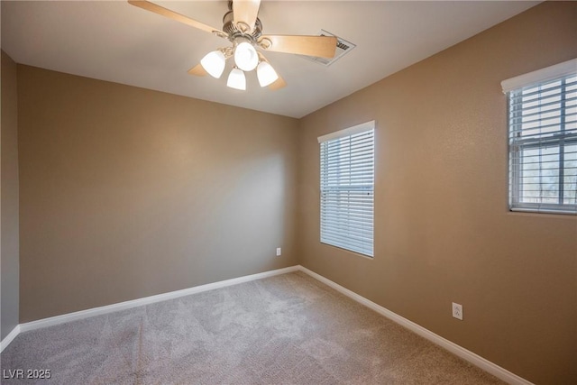 unfurnished room featuring ceiling fan and carpet