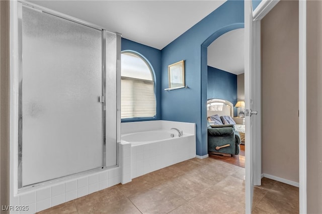 bathroom with tile patterned floors and shower with separate bathtub