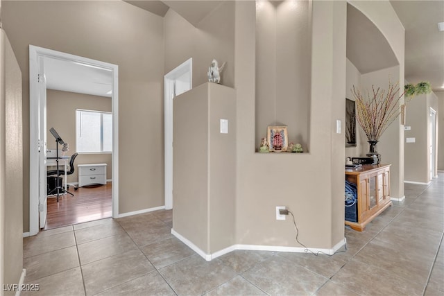 hall featuring light tile patterned floors