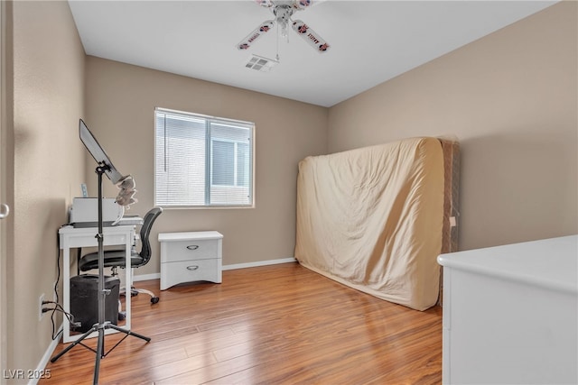 office area with ceiling fan and wood-type flooring