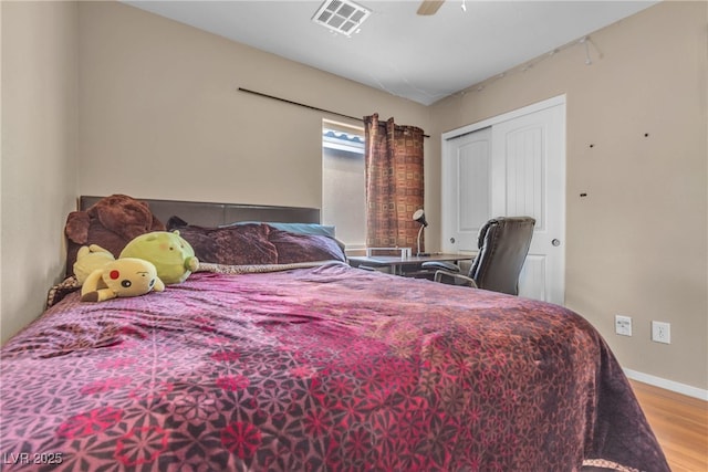 bedroom featuring ceiling fan, a closet, and light hardwood / wood-style flooring