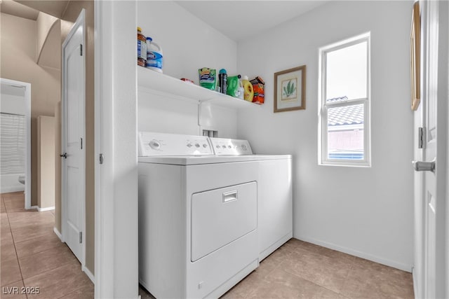 clothes washing area featuring light tile patterned floors and independent washer and dryer