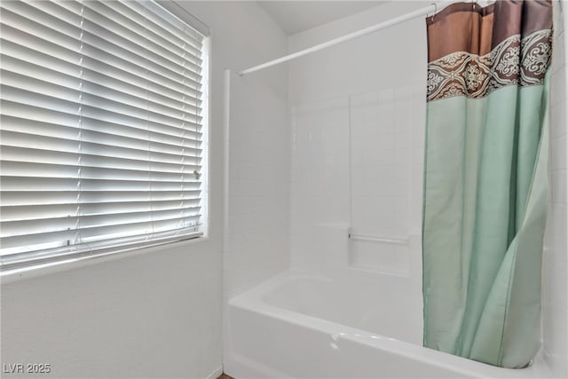 bathroom with shower / tub combo with curtain