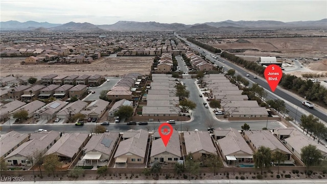 birds eye view of property with a mountain view