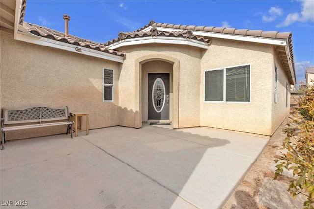 doorway to property featuring a patio