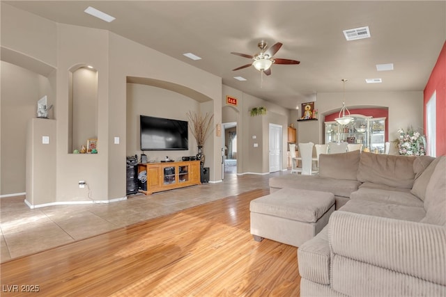 living room with hardwood / wood-style floors, vaulted ceiling, and ceiling fan