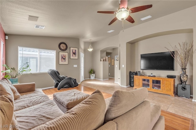 living room featuring ceiling fan and light wood-type flooring